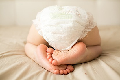 bottom a small child is sleeping in a diaper